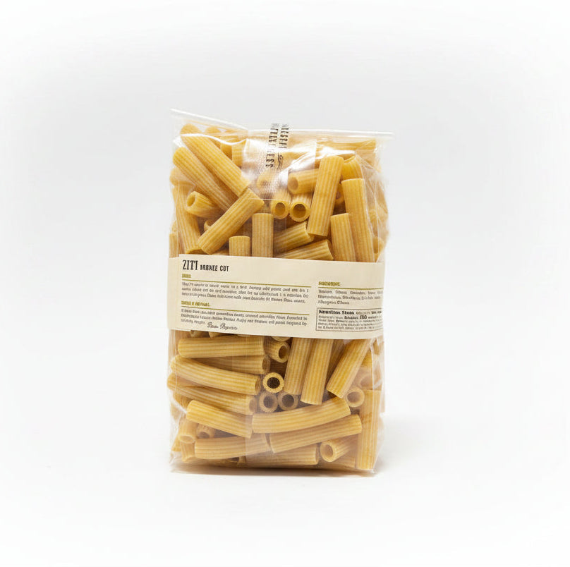 Bag of Ziti pasta with a label on a black surface and gray background