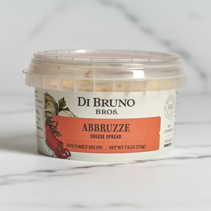 A container of Di Bruno Bros. Abbruzze Cheese Spread on a light background.