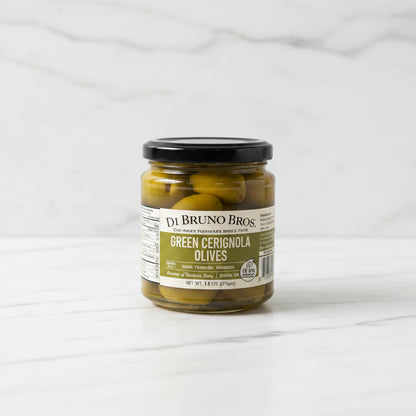 Jar of DeBruno Bros Green Cerignola Olives on a white surface with a blurred background