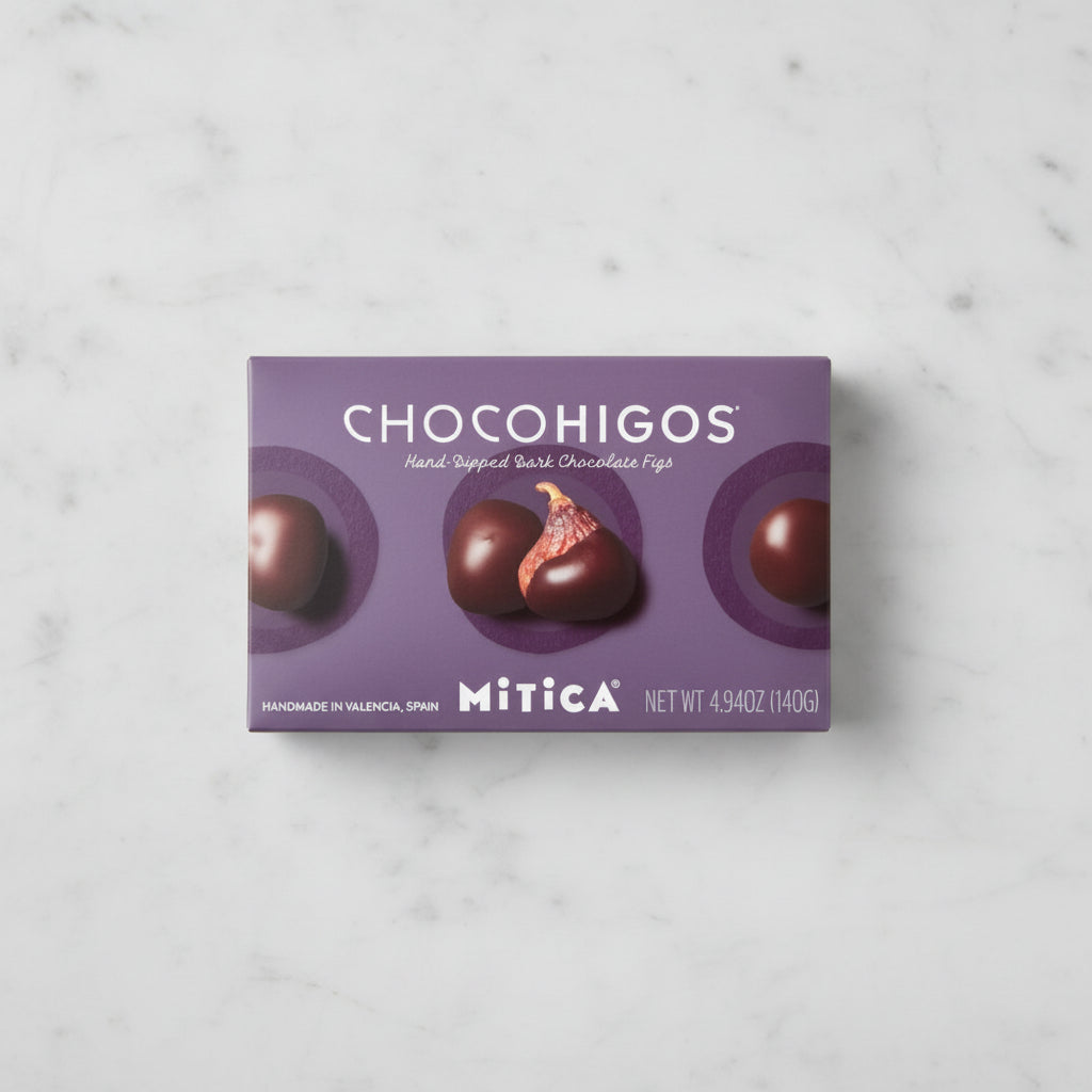 A rectangular box of Chocohigos hand-dipped dark chocolate figs by Mitica, featuring a purple background with four
chocolate-covered figs and the brand name clearly visible.