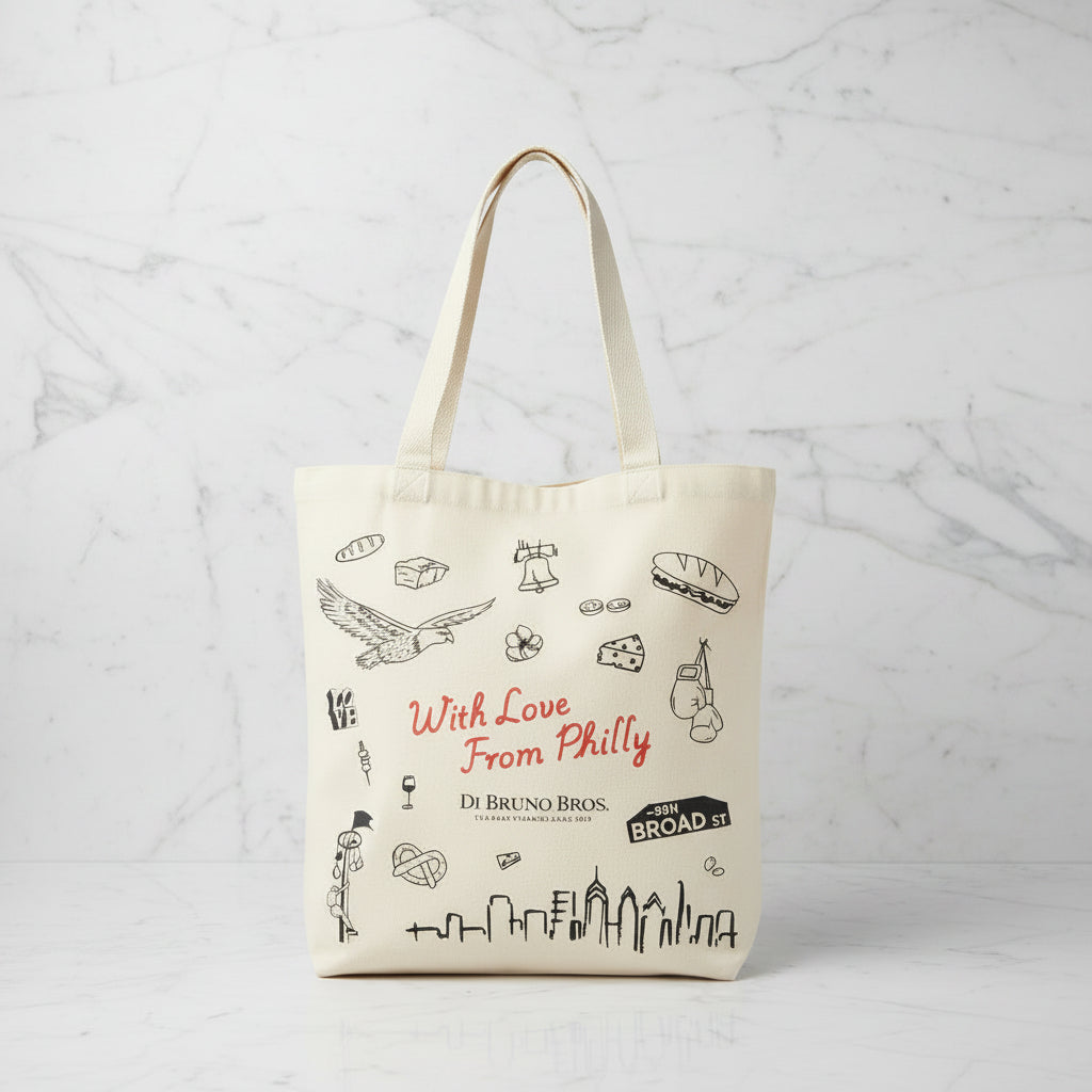 Tote bag with Philadelphia-themed graphics and text on a wooden surface